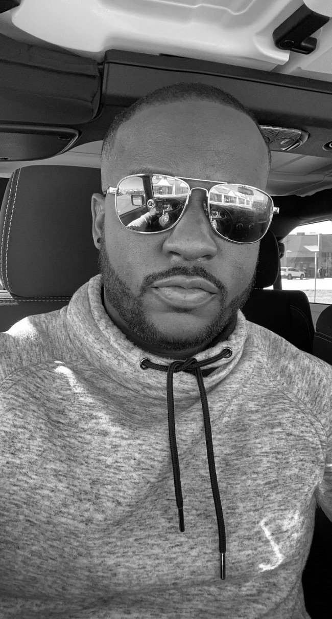 Derrick Aryee seated in a vehicle